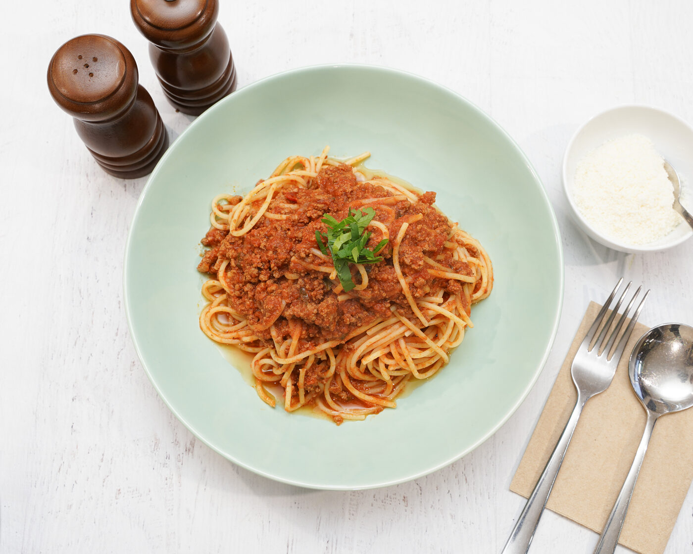 Spaghetti Bolognese topped with fresh basil
