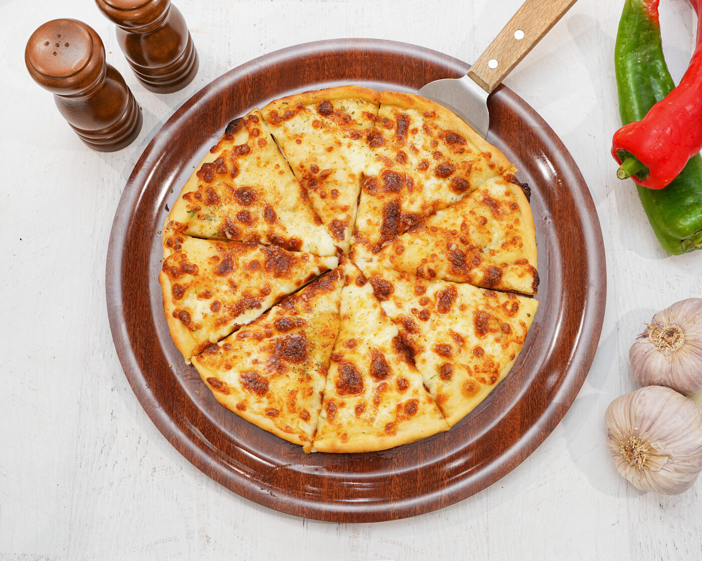 Garlic and cheese pizza fresh from the oven, sliced into eight