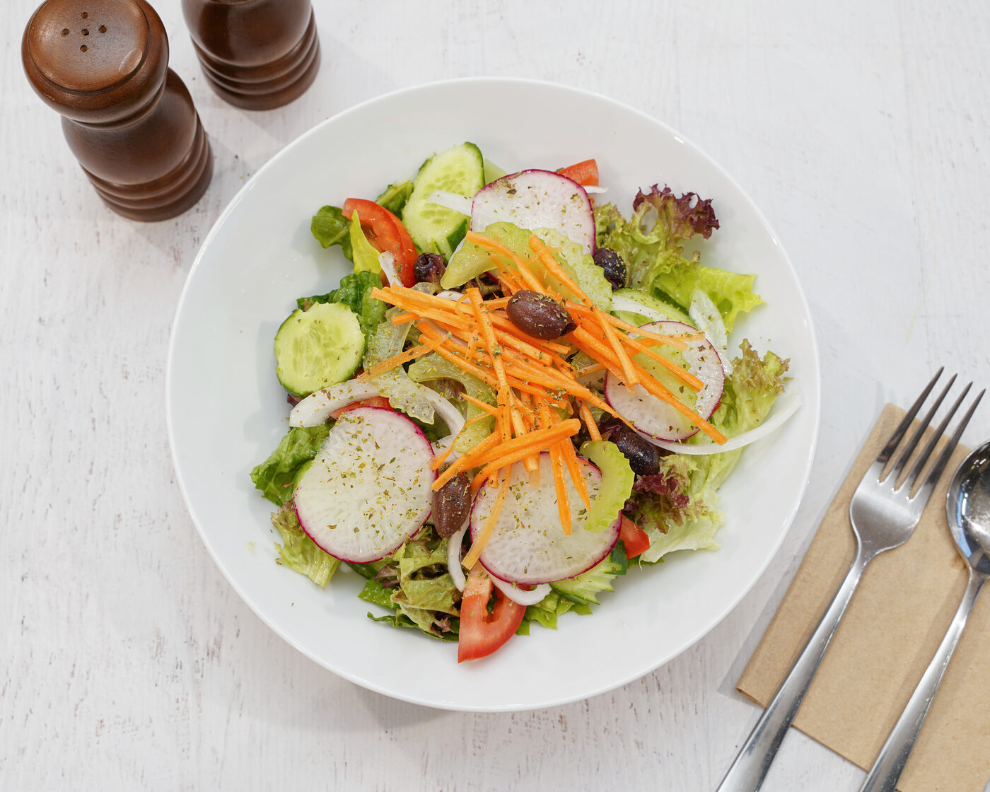 Fresh mixed Italian salad with radish, carrot, olives and cucumber