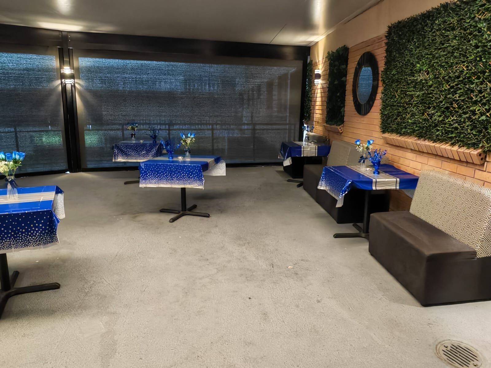 Terrace tables dressed in blue for an event in the evening